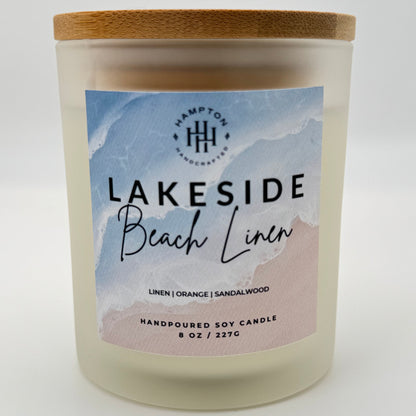 Candle with 'Lakeside Beach Linen' label on a white background