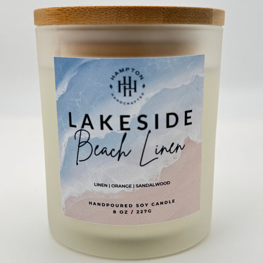 Candle with 'Lakeside Beach Linen' label on a white background