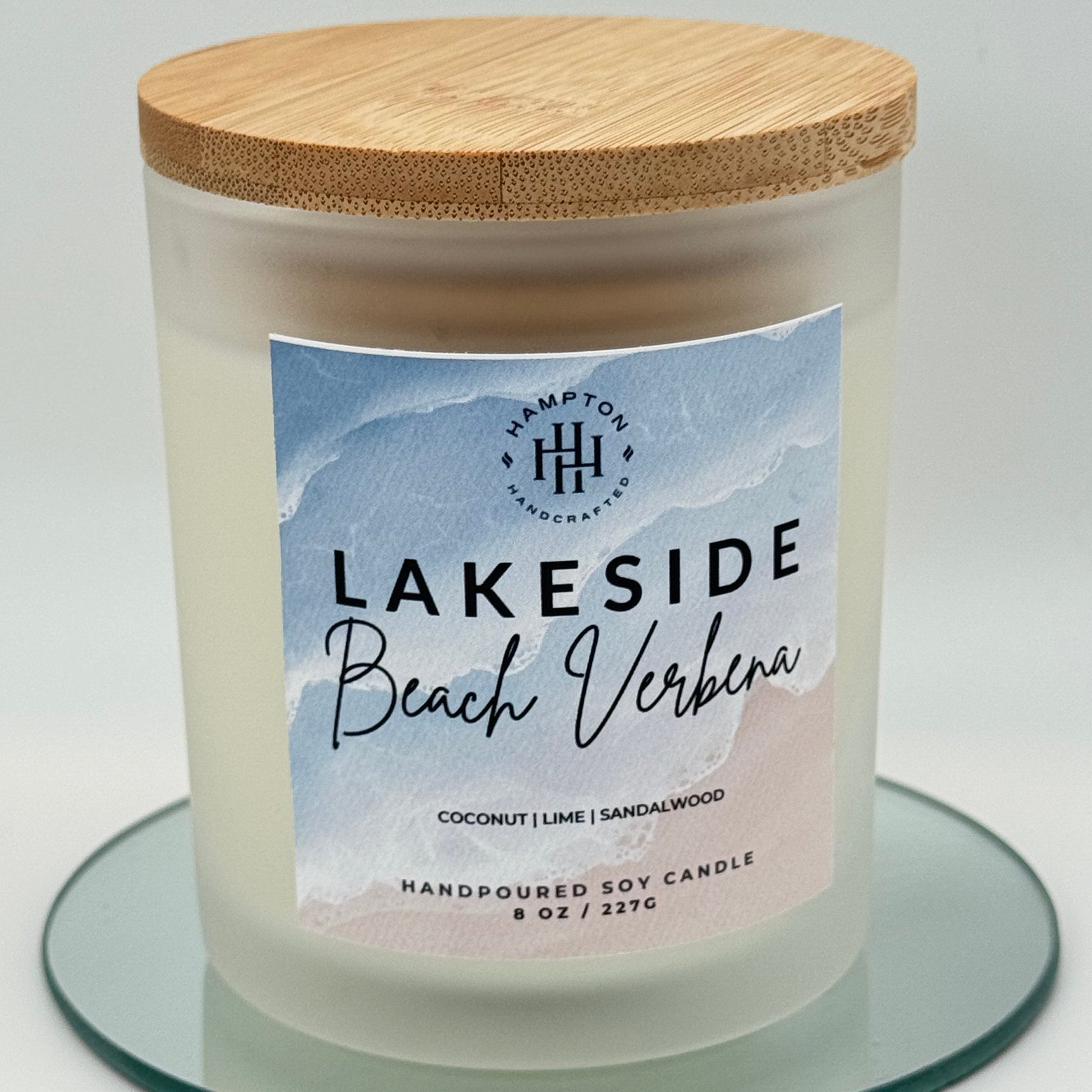 Candle with a label reading 'Lakeside Beach Verbena' on a light background
